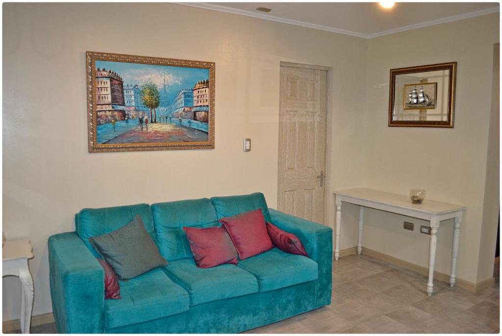 Sala interior del hotel con sofá turquesa y mesa auxiliar